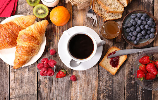 croissants, cup of coffee, fruits, breakfast restaurant