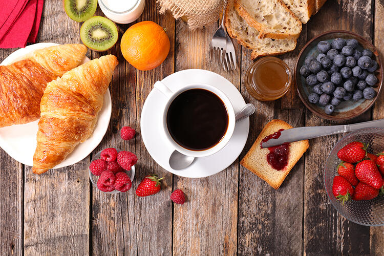 croissants, cup of coffee, fruits, breakfast restaurant