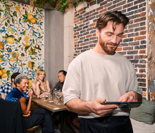 Smiling restaurant owner using TheFork