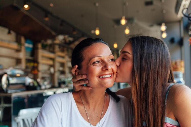 Girl kissing mum