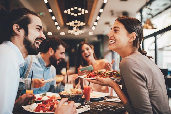 Group of friends eating and smiling